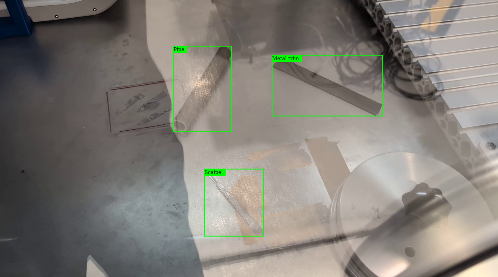 A sharp object detection system, developed at RAICo1, could help prevent damage to robot manipulators in gloveboxes, and pave the way for new teleoperated and autonomous gloveboxes.

Gloveboxes are a staple of decommissioning, allowing operators to manipulate tools and hazardous materials in a contained environment through thick gloves. But thick gloves mean a lack of fine motor control, and a potential risk to operators if torn. Nuclear decommissioning facilities – including those operated by RAICo members – have an interest in “hands out of gloveboxes” through the use of teleoperated arms, robots, and automated systems instead of gloved hands.

A key element of success is enabling robots to detect the objects in gloveboxes. Initially, this may be simply to avoid harm, for example, a system that sees a sharp object and automatically prevents the robot arm (which is wrapped in a protective glove to prevent contamination) from going near it. But, as these systems become more automated and capable, they will need to be able to recognise and manipulate objects with the precision of a human hand.

In a recently completed project, RAICo took the first steps towards creating such an object detection system. 
