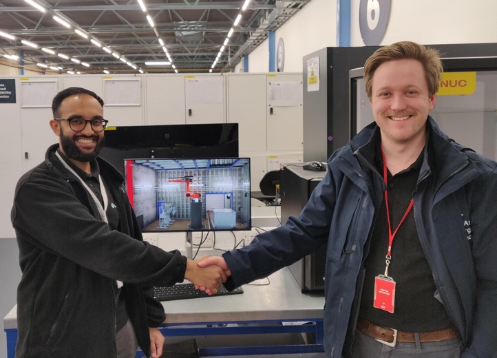 Idris Hussain (left) from the Sellafield Remote Technologies Group receiving handover of the system from Ronan Kelly (right) of UKAEA on behalf of RAICo
